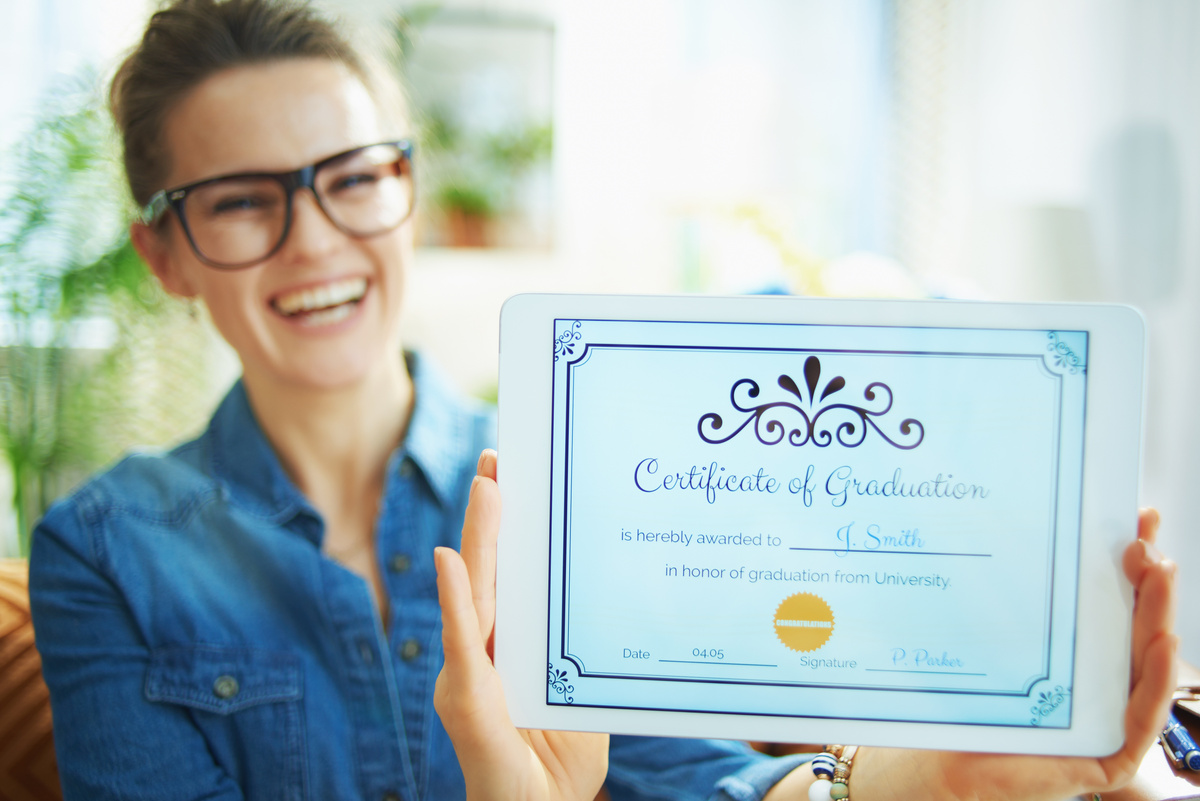 happy woman showing Certificate of Graduation