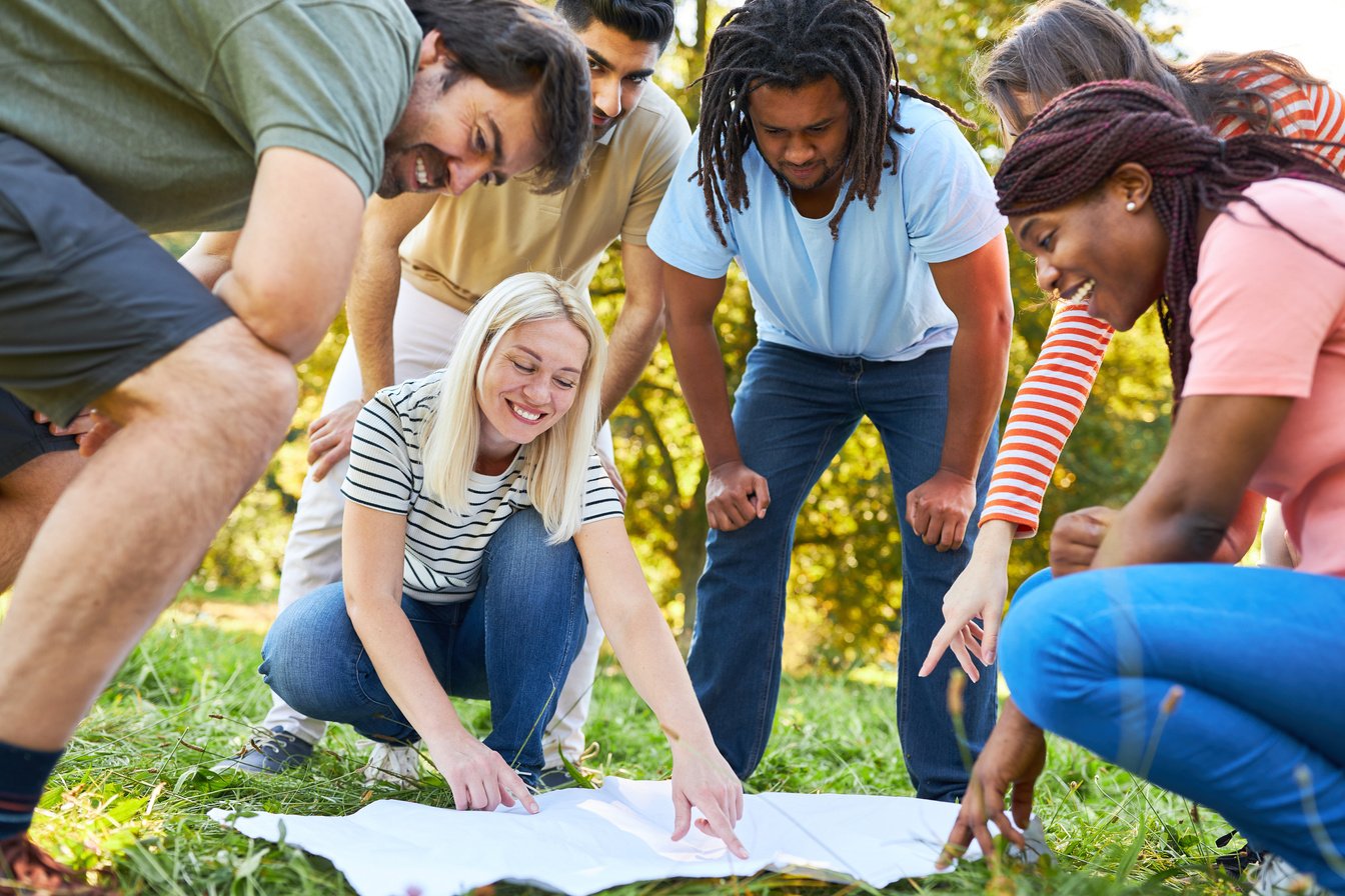 Start-up Team People Look at Map during Treasure Hunt