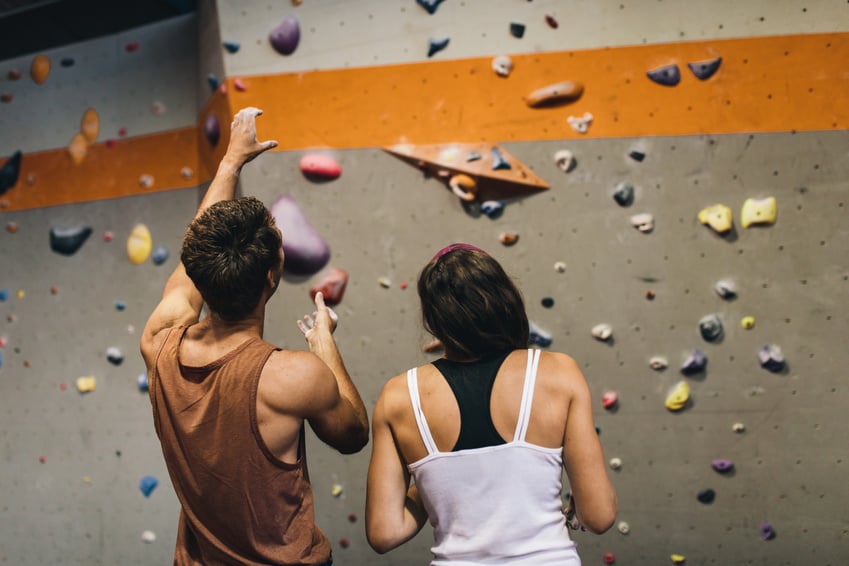 Man and Woman at an Indoor Rock Climbing Gym